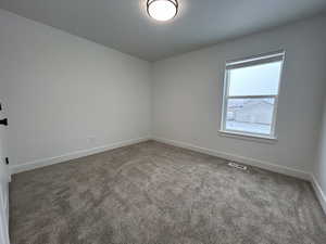 View of carpeted spare room