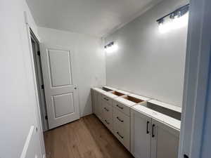 Upstairs Bathroom with hardwood / wood-style floors and double sinks