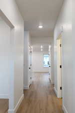 Hallway with light wood-type flooring