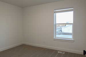 Spare room with carpet floors and a healthy amount of sunlight