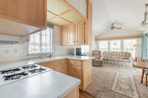 Kitchen featuring open floor plan, light brown cabinetry, and plenty of natural light