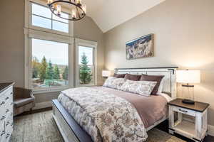 Bedroom with high vaulted ceiling and a chandelier