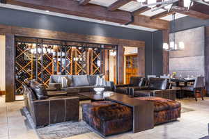 Wine room featuring beamed ceiling and light tile patterned floors