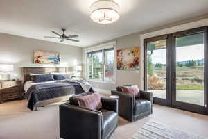 Carpeted bedroom featuring access to exterior and ceiling fan