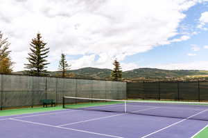 View of tennis court with a mountain view