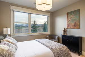 Bedroom featuring light carpet