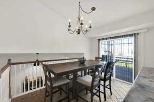 Dining space with vaulted ceiling and an inviting chandelier