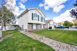 View of property exterior featuring a lawn