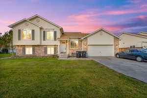 Tri-level home with a yard and a garage