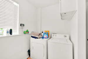 Laundry room featuring washing machine and clothes dryer