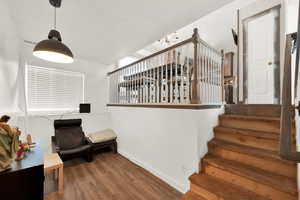 Staircase featuring wood-type flooring