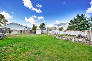 View of yard featuring a storage unit