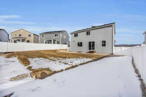 View of snow covered rear of property