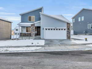 View of front facade with a garage and covered porch