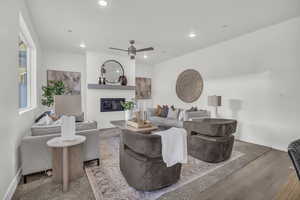 Living room with hardwood / wood-style floors and ceiling fan