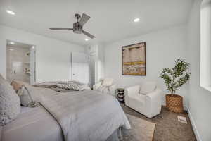 Bedroom featuring carpet flooring, ceiling fan, and ensuite bathroom