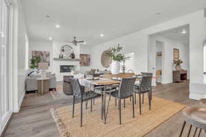 Dining area with ceiling fan, light hardwood / wood-style flooring, and plenty of natural light