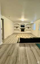 Unfurnished living room with a textured ceiling and hardwood / wood-style flooring