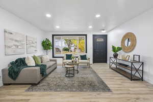 Living room with light hardwood / wood-style floors