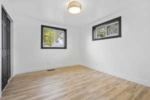 Unfurnished room with light wood-type flooring