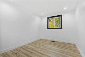 Unfurnished room with light hardwood / wood-style floors