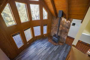 Living room with beam ceiling, high vaulted ceiling, and wooden ceiling