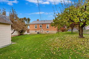 Rear view of house with a back lawn