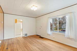 Empty room featuring light hardwood flooring