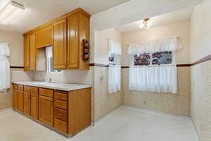 Kitchen featuring tall cabinets and dining.