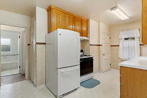 Kitchen featuring white appliances