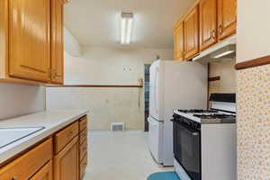 Kitchen featuring sink and white gas range oven