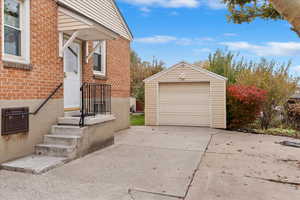 View of driveway and single car garage