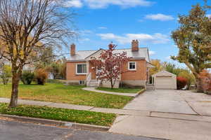 View of front of house featuring a front yard and a garage