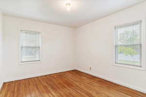 Unfurnished room with hardwood flooring