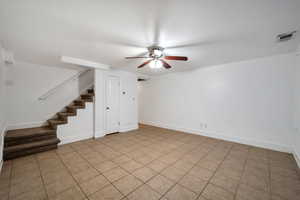 Tiled empty room with ceiling fan