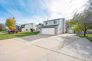 View of front of property with a garage and a front yard