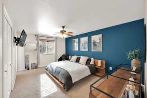 Bedroom featuring ceiling fan, a closet, carpet, and a textured ceiling