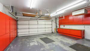 Garage with a lot of storage cupboards, workbench, 220 V, Heat/AC, and ventilation system