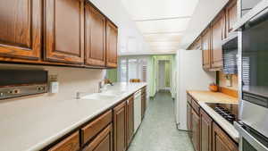 Kitchen with white appliances and sink