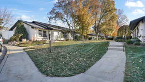 View of side of home featuring a yard