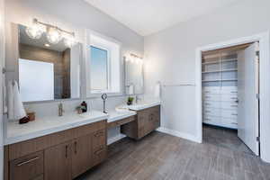 Bathroom with vanity and a tile shower