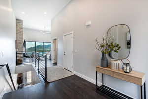 Foyer entrance featuring a mountain view, dark hardwood / wood-style flooring, ceiling fan, and a high ceiling