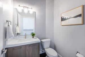 Bathroom featuring vanity and toilet