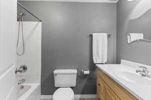 Full bathroom featuring vanity,  shower combination, and toilet