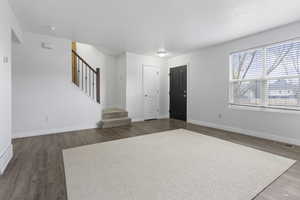 Foyer entrance with dark hardwood / wood-style floors