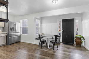 Dining area with plenty of natural light and dark hardwood / wood-style floors