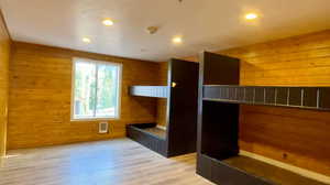 Interior space featuring hardwood / wood-style floors and wood walls