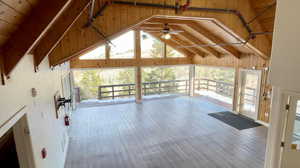 Interior space featuring vaulted ceiling with beams, wooden ceiling, and a healthy amount of sunlight