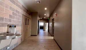 Hallway with light hardwood / wood-style floors