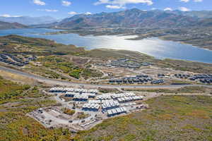 Birds eye view of property featuring a water and mountain view